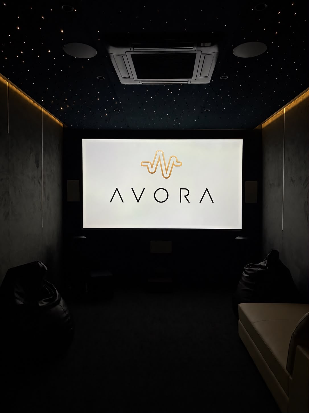 An Avora private cinema — acoustically treated walls, fibre-optic star ceiling and a full-width screen